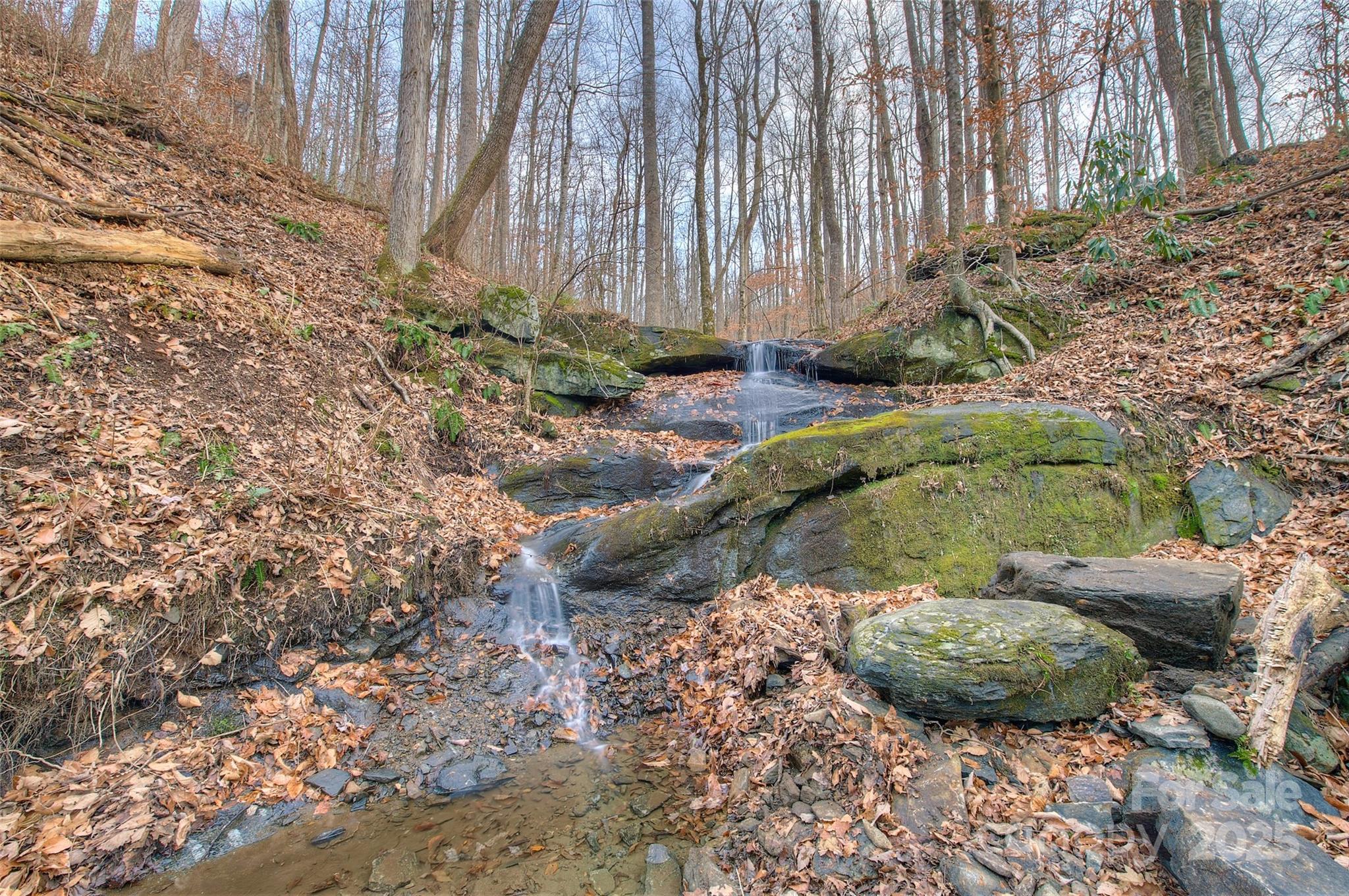 a backyard of a house with a yard and outdoor seating
