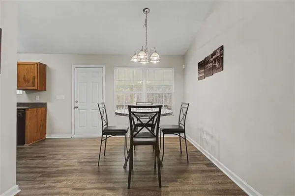 a view of a dining room with furniture and wooden floor