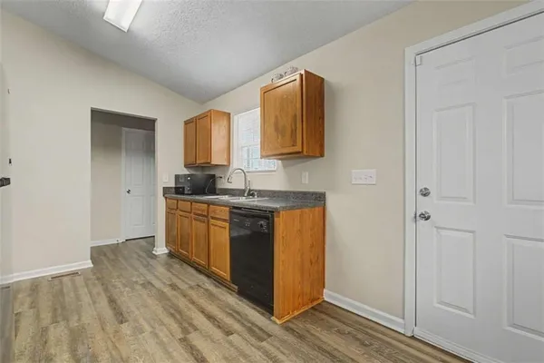 a kitchen with stainless steel appliances granite countertop a refrigerator and a sink