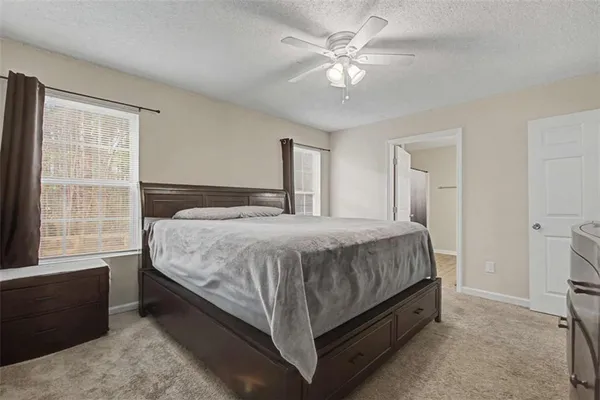 a spacious bedroom with a bed and a window