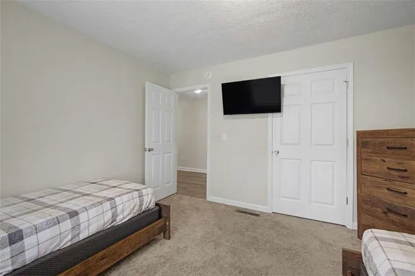 a bedroom with a bed and a television