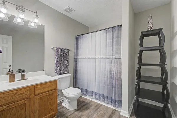 a bathroom with a toilet a sink and shower