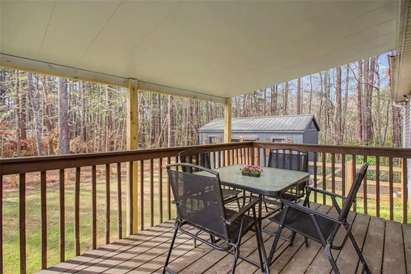 a dining room with furniture window and wooden floor