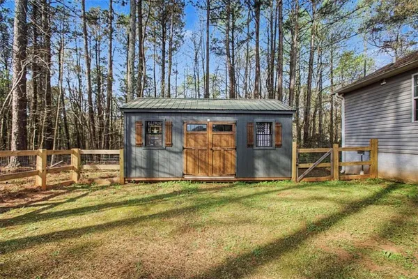 a view of a house with pool and sitting area