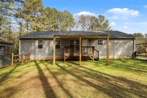 a view of a house with backyard porch and sitting area