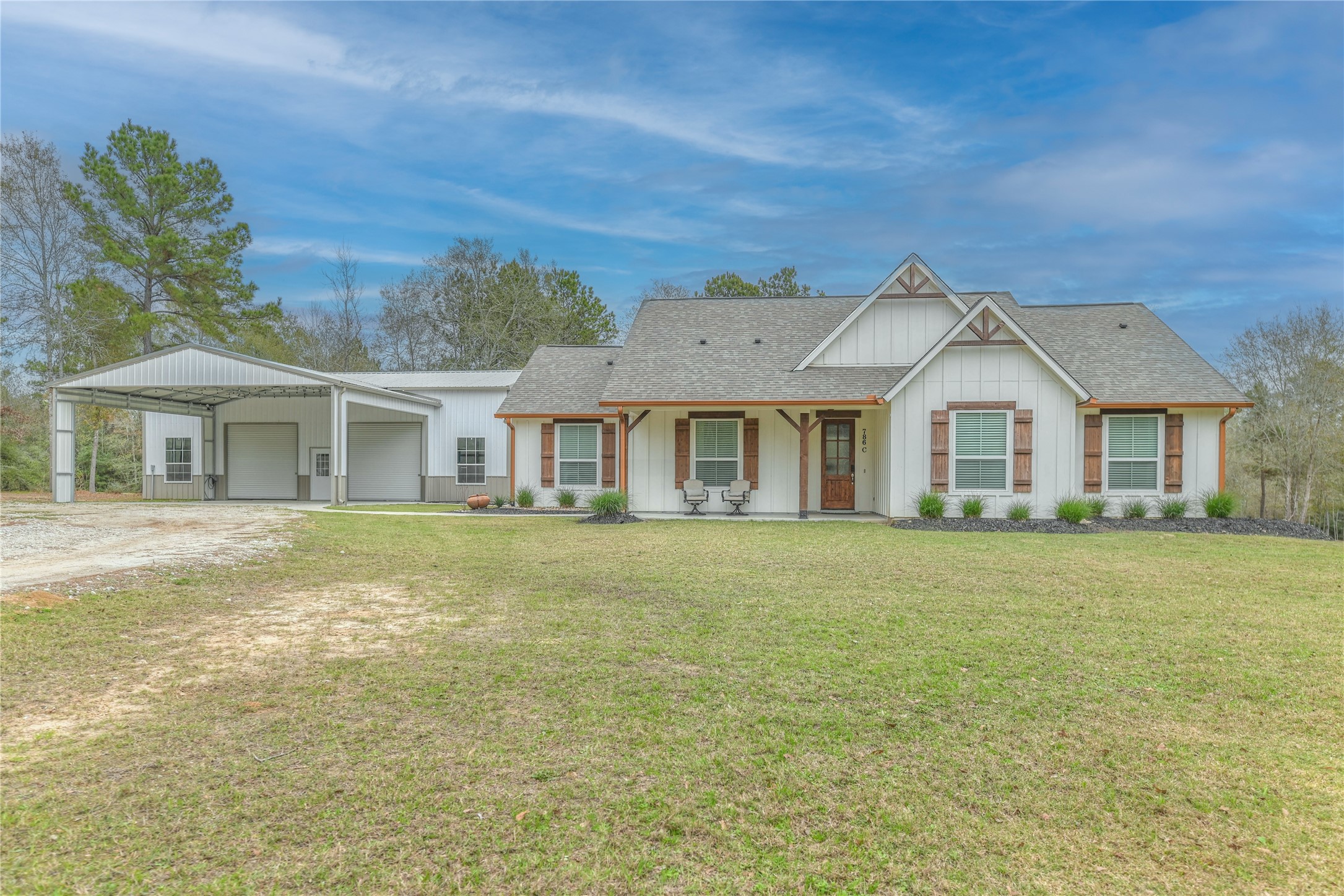 786 Farm To Market 230, Unit C Trinity, TX 75862 - Photo 2 of 41 a front view of a house with a garden