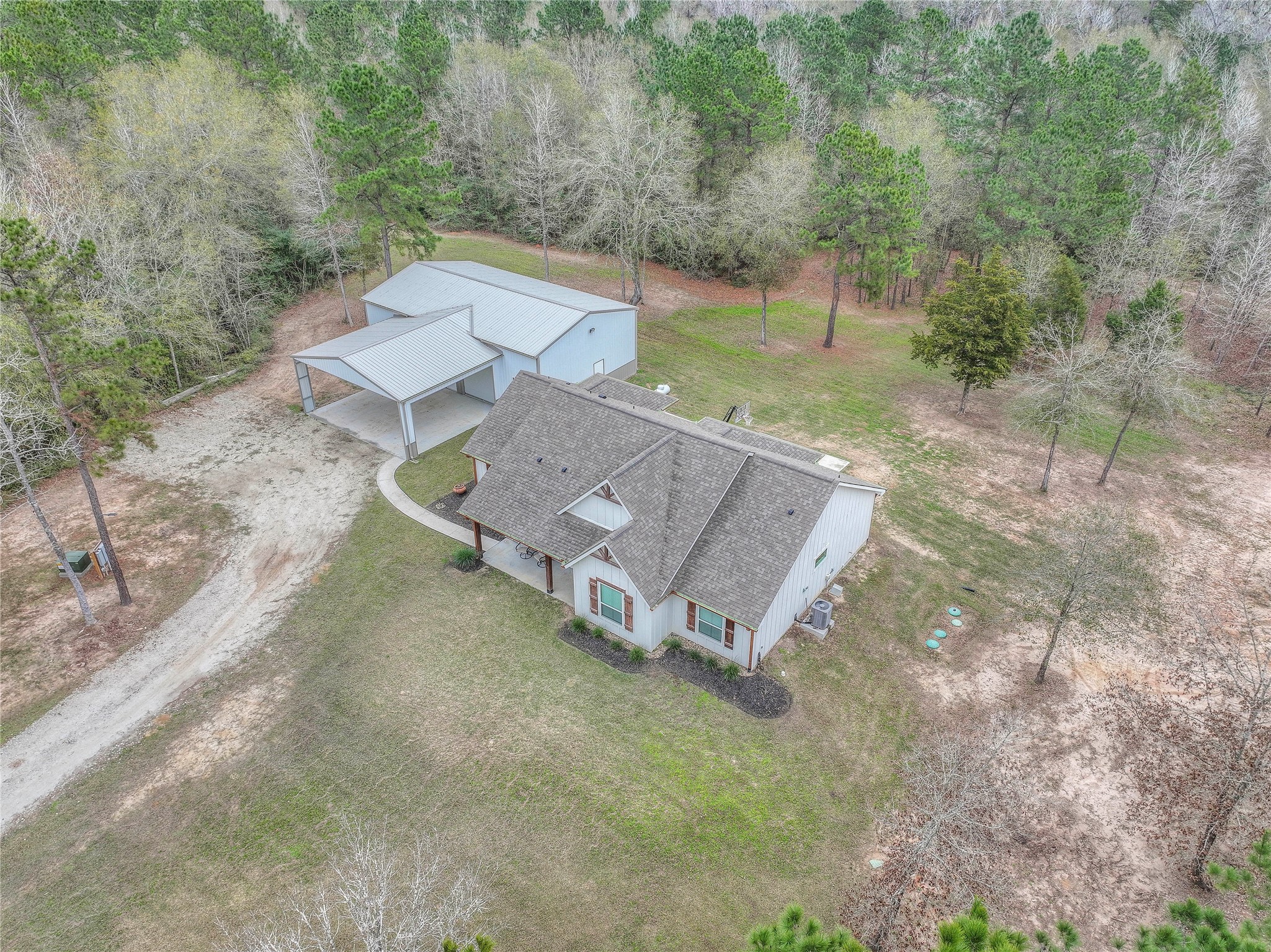 786 Farm To Market 230, Unit C Trinity, TX 75862 - Photo 3 of 41 an aerial view of a house with yard and trees in the background