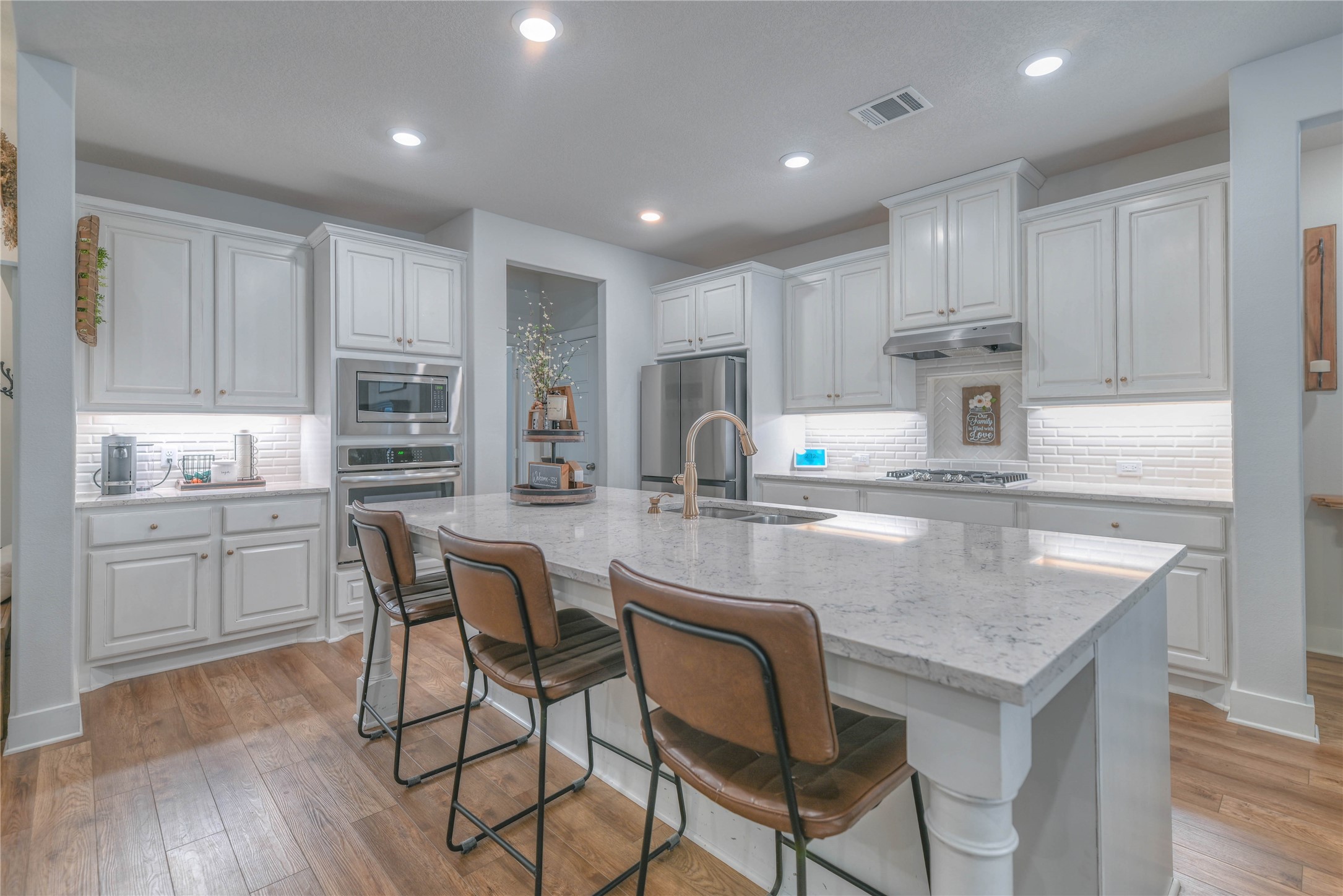 786 Farm To Market 230, Unit C Trinity, TX 75862 - Photo 9 of 41 a kitchen with kitchen island granite countertop wooden floors and white cabinets