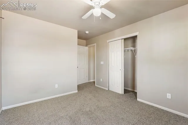 a view of a backyard with wooden fence