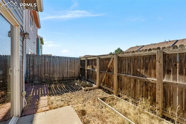 a view of house with backyard space and balcony