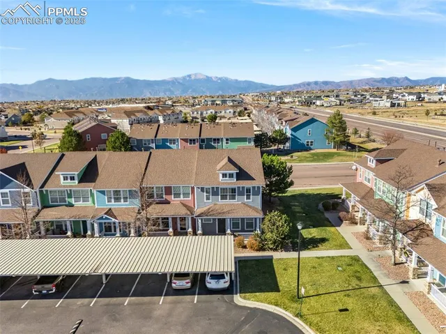 an aerial view of a house with yard and mountain view