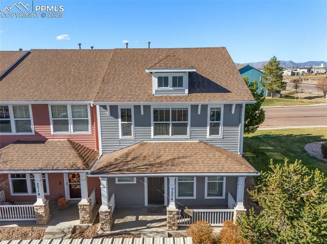a aerial view of residential houses with buildings