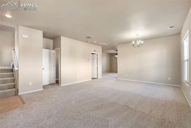 an empty room with a cabinet and mirrors