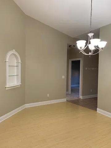 a view of a kitchen with a sink and chandelier