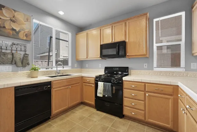 a kitchen with a sink stove and microwave