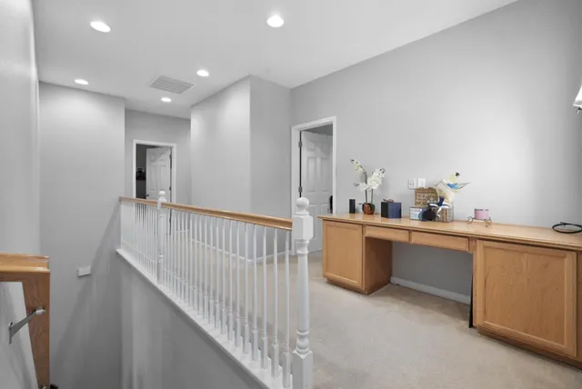 a view of a kitchen with kitchen island a sink a wooden floor and a window