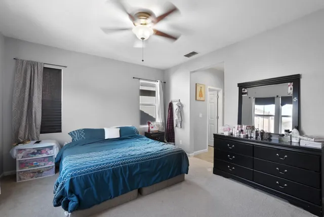 a bedroom with a bed and a dresser