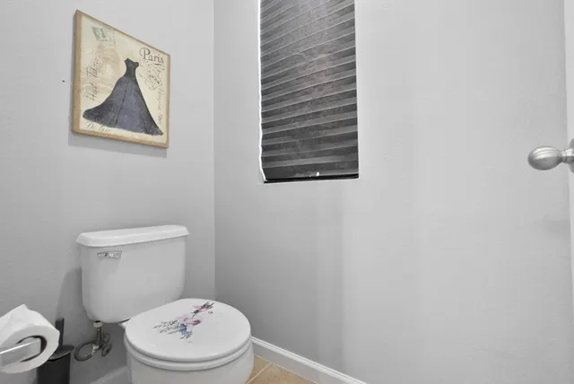 a white toilet sitting next to a white walls