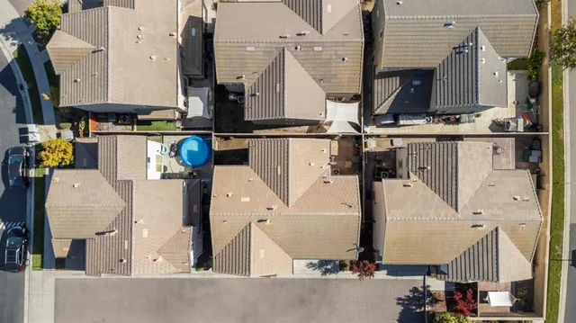 an aerial view of residential houses with outdoor space