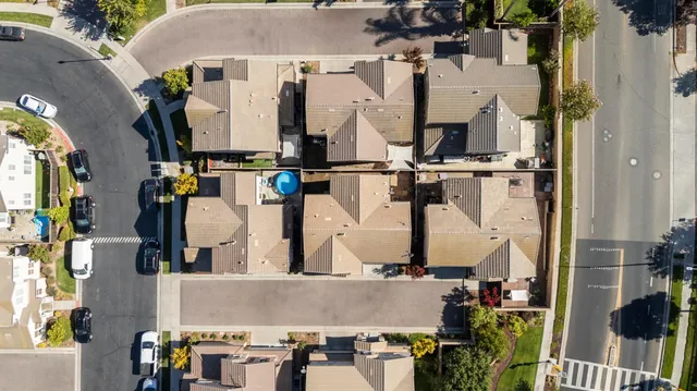 an aerial view of residential houses with outdoor space