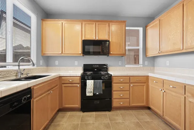 a kitchen with a sink and a stove