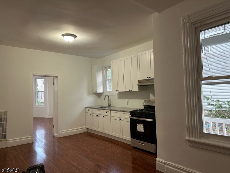 247 South 8th Street, Unit 1 Newark, NJ 07103 - Photo 3 of 13 a view of a kitchen with electric appliances and windows