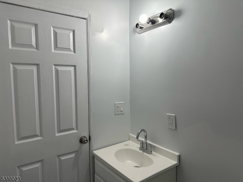 247 South 8th Street, Unit 1 Newark, NJ 07103 - Photo 5 of 13 a bathroom with a sink a mirror and shower