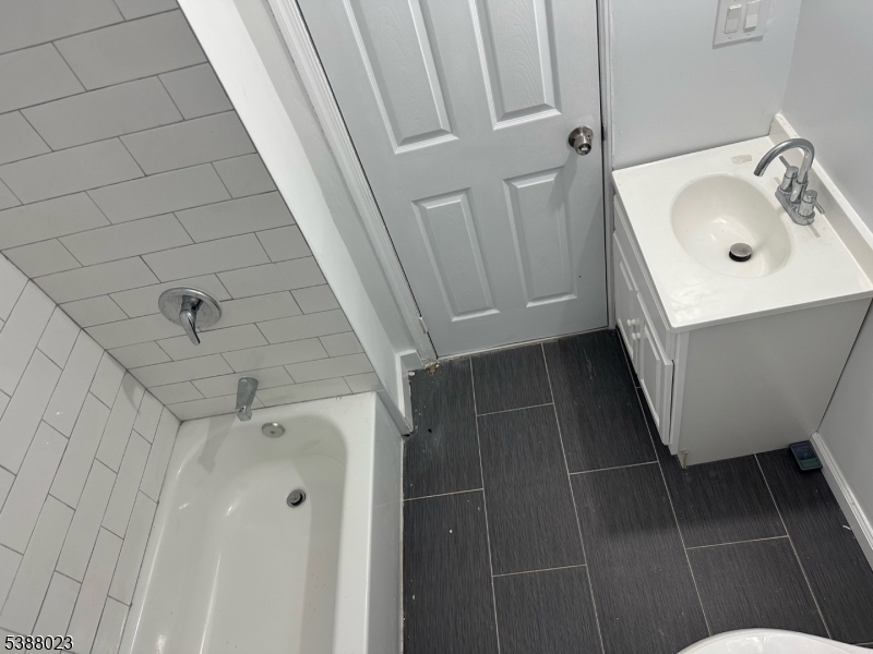 247 South 8th Street, Unit 1 Newark, NJ 07103 - Photo 6 of 13 a bathroom with a sink a toilet a mirror and shower