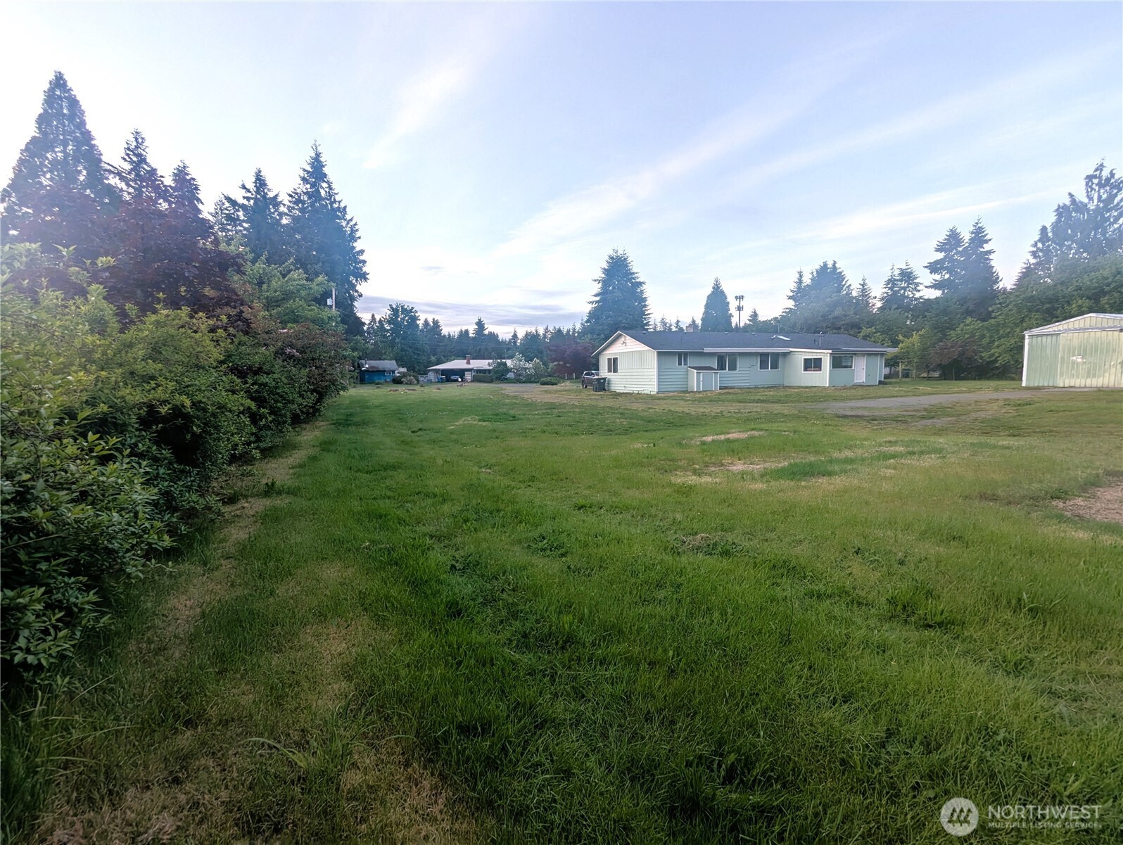 8927 178th Avenue Southwest Rochester, WA 98579 - Photo 15 of 38 a view of a big room with a big yard and a large tree