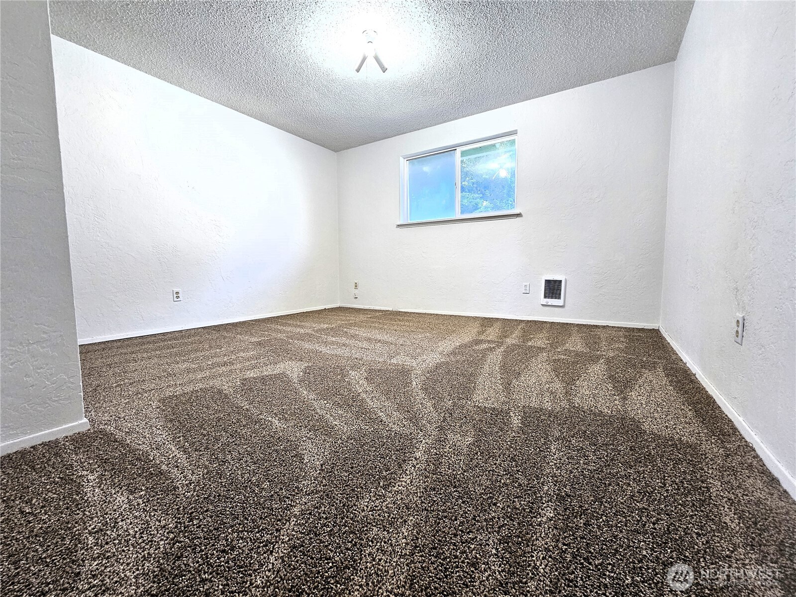 8927 178th Avenue Southwest Rochester, WA 98579 - Photo 19 of 38 an empty room with a empty space and windows