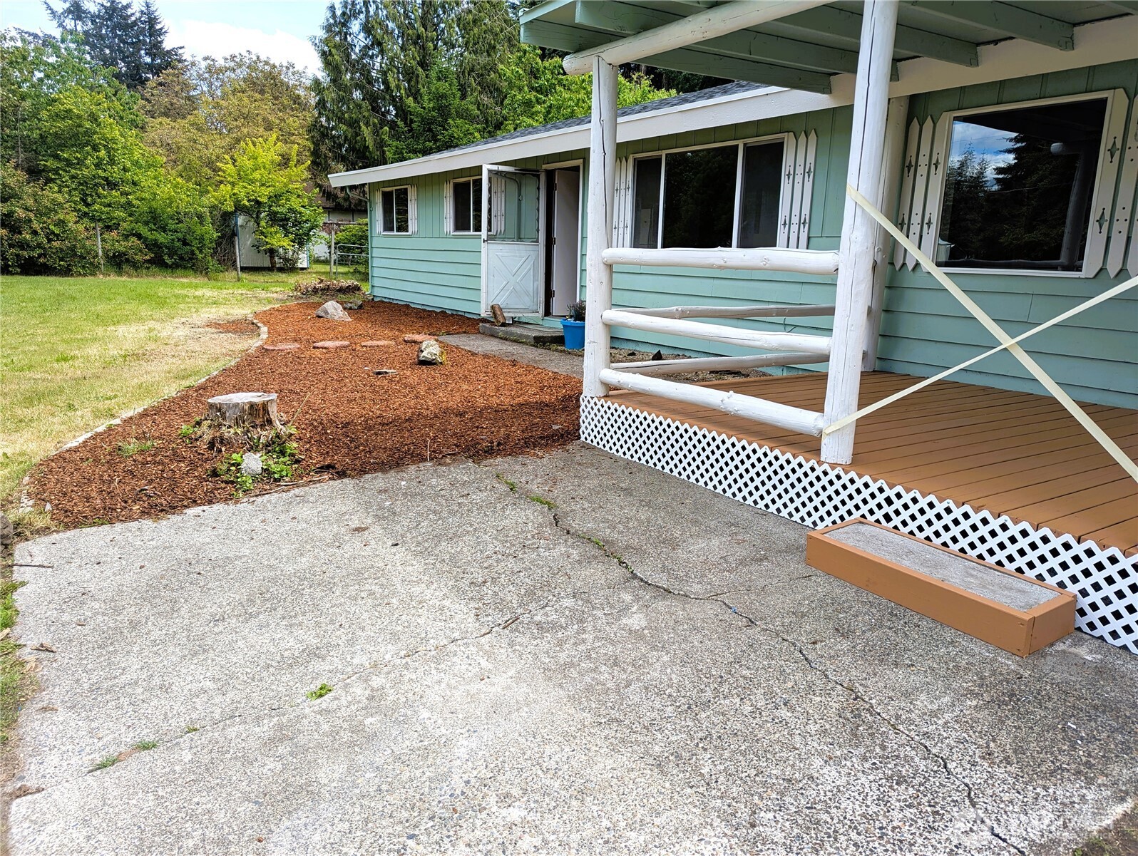 8927 178th Avenue Southwest Rochester, WA 98579 - Photo 7 of 38 a backyard of a house with wooden floor