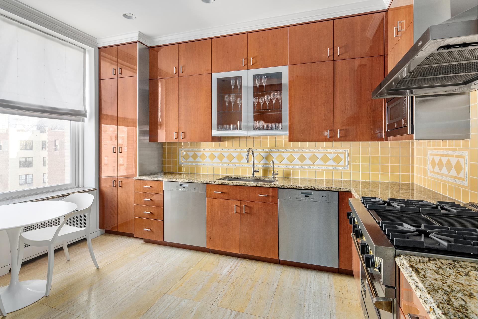 755 Park Avenue, Unit PHA Manhattan, NY 10021 - Photo 14 of 16 a kitchen with granite countertop a stove and a sink