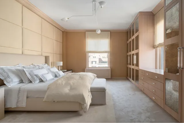 a bedroom with a balcony a bed and a cabinets