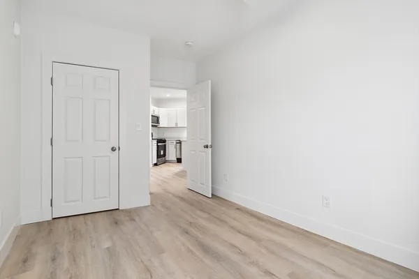 a view of a hallway with wooden floor