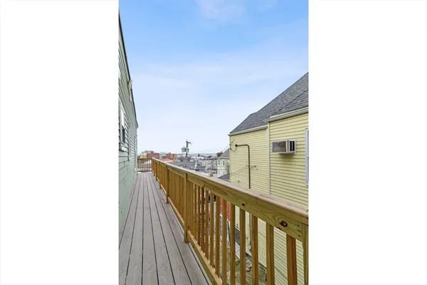 a view of a living room with a table and chairs