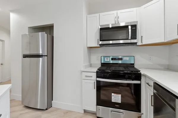 a kitchen with a stove and a microwave