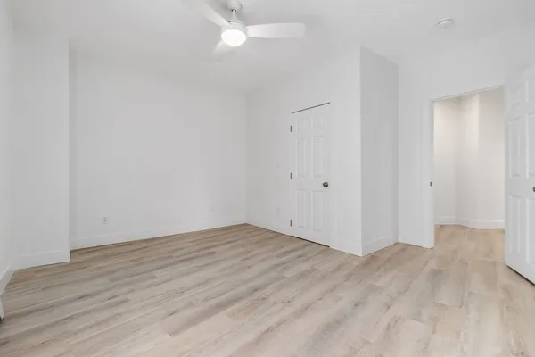 a view of an empty room with wooden floor