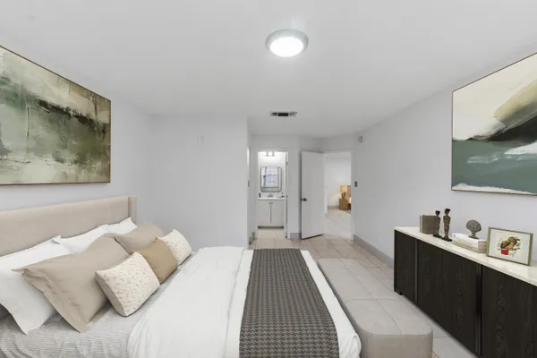 a bedroom with bed and window