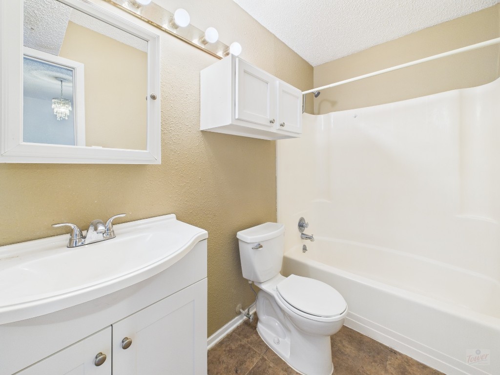 910 Duncan Lane, Unit 26 Austin, TX 78705 - Photo 11 of 31 a bathroom with a sink a toilet and a mirror