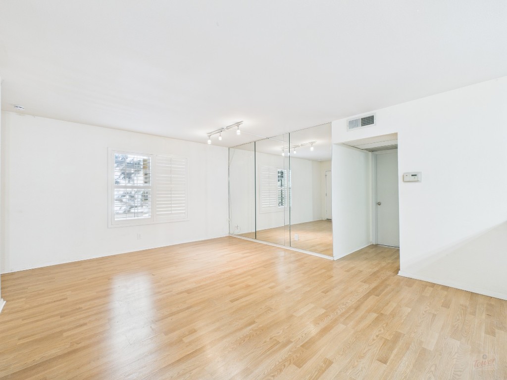 910 Duncan Lane, Unit 26 Austin, TX 78705 - Photo 14 of 31 a view of an empty room with wooden floor