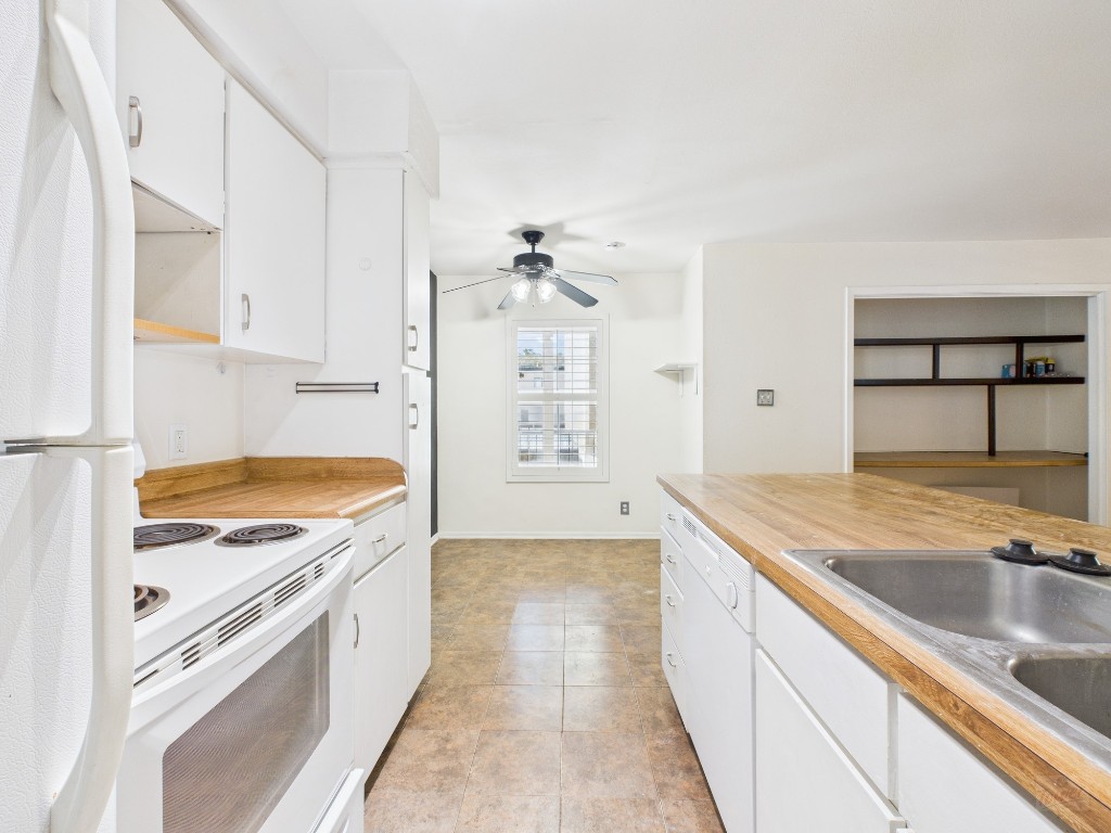 910 Duncan Lane, Unit 26 Austin, TX 78705 - Photo 21 of 31 a kitchen with granite countertop a sink stove and cabinets