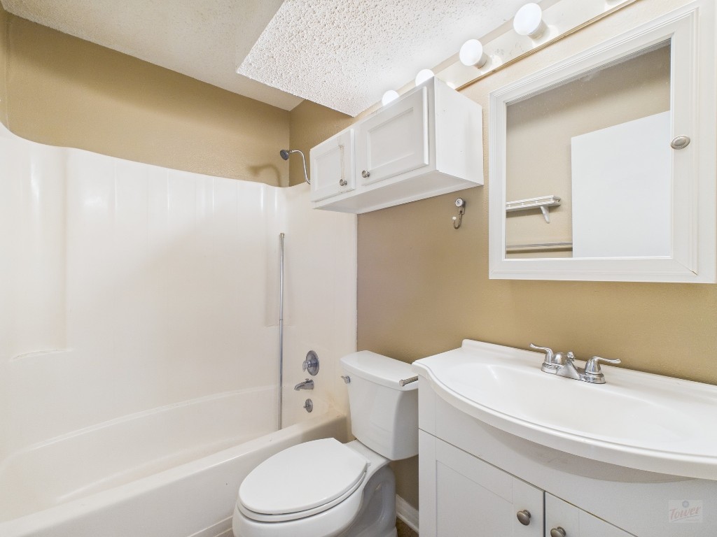 910 Duncan Lane, Unit 26 Austin, TX 78705 - Photo 22 of 31 a bathroom with a sink a toilet and shower