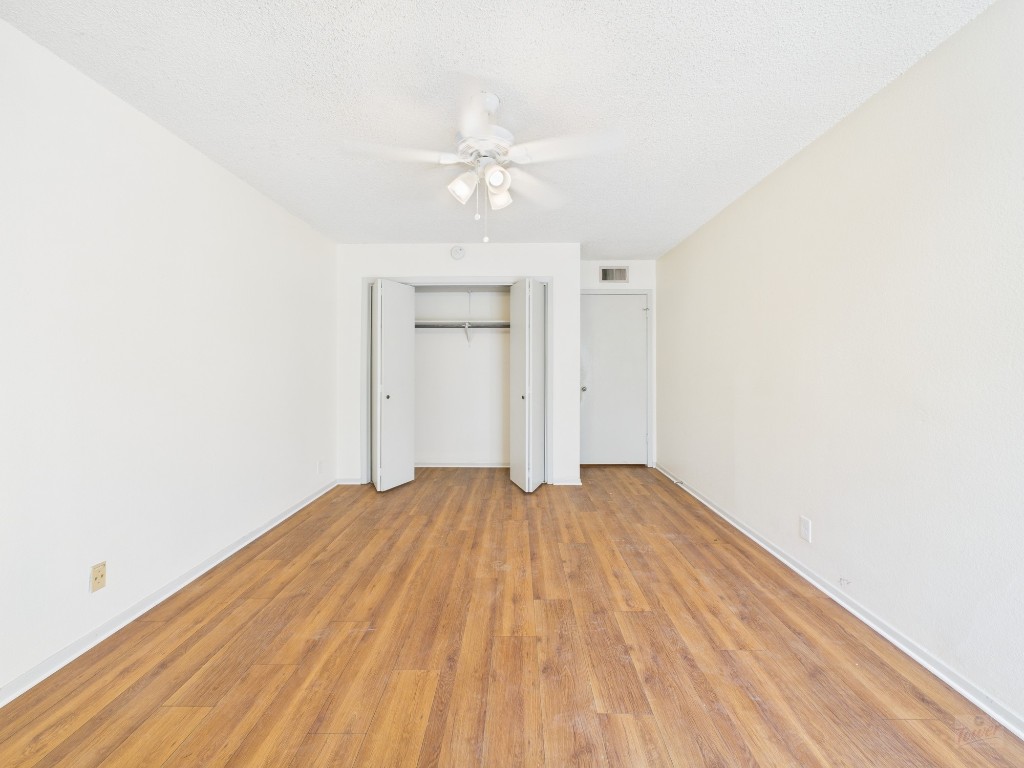 910 Duncan Lane, Unit 26 Austin, TX 78705 - Photo 25 of 31 a view of empty room with wooden floor