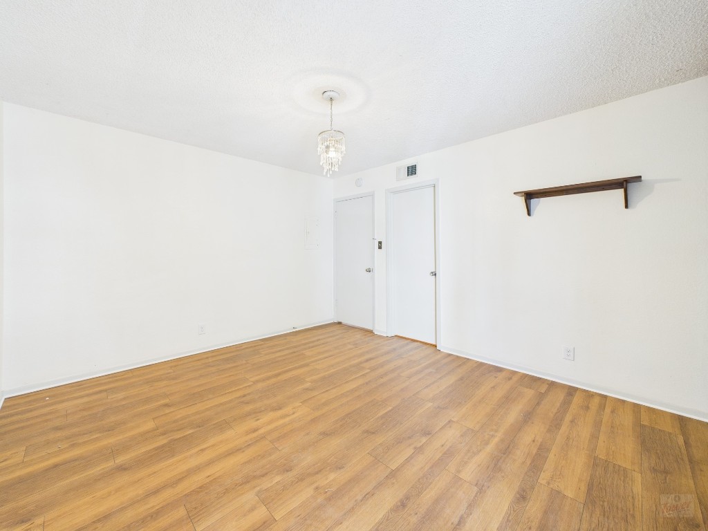 910 Duncan Lane, Unit 26 Austin, TX 78705 - Photo 7 of 31 a view of empty room with wooden floor