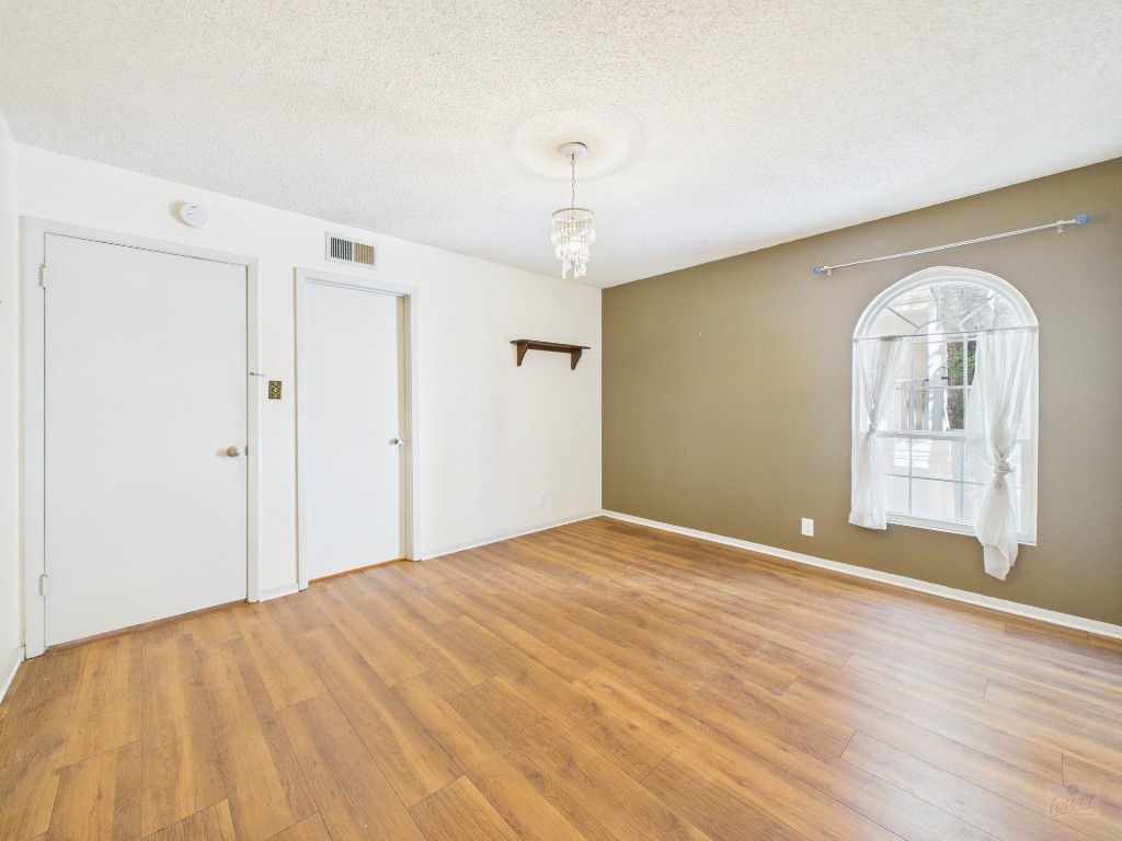 910 Duncan Lane, Unit 26 Austin, TX 78705 - Photo 8 of 31 a view of empty room with wooden floor and fan