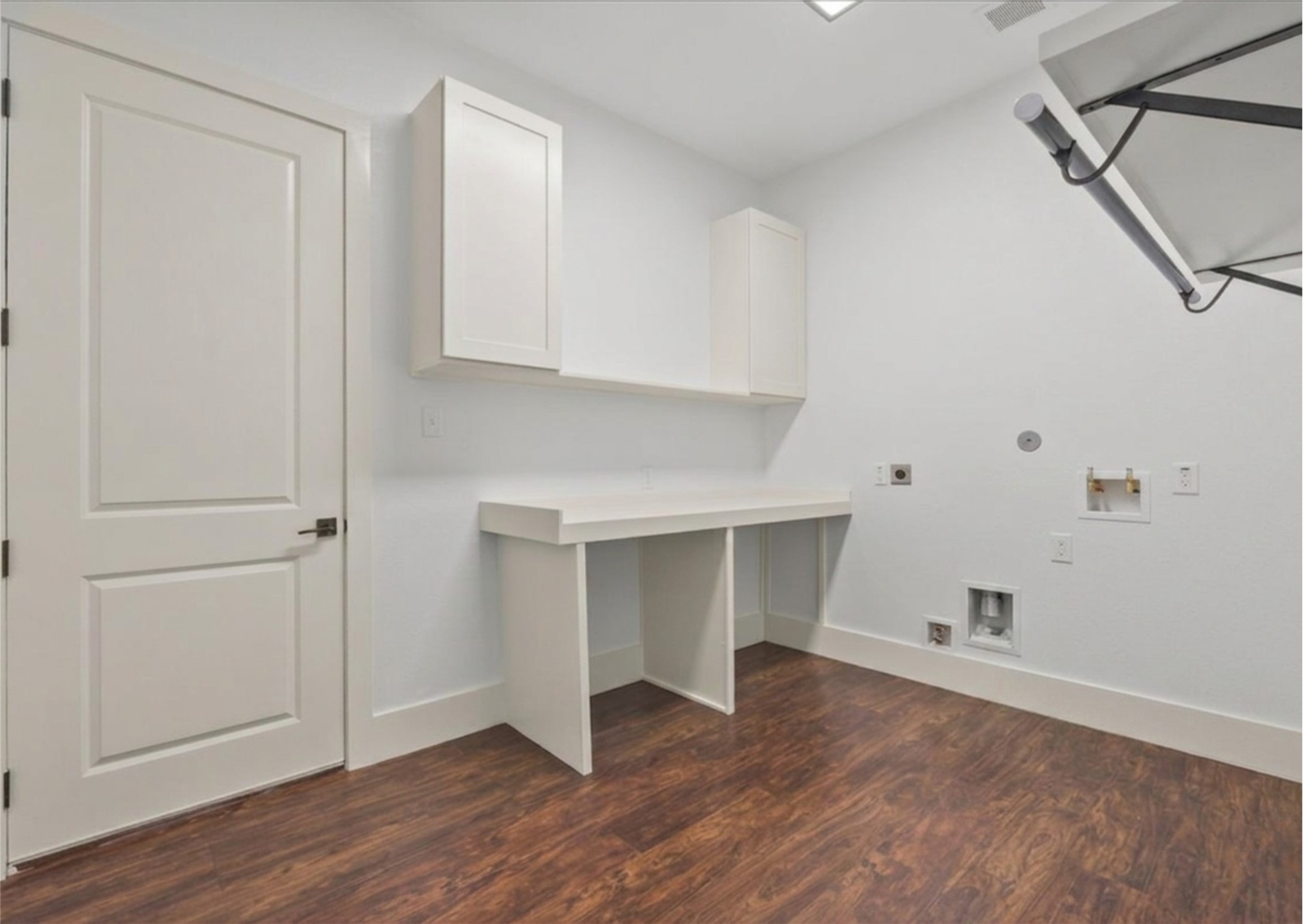 3237 Harkey Road Pearland, TX 77584 - Photo 34 of 46 Spacious utility room with built-in cabinetry, folding station, and hanging space.