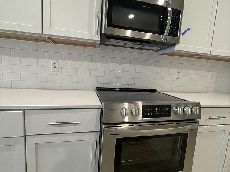702 Mickelson Way, Unit 702 Lebanon, TN 37087 - Photo 5 of 17 a stove top oven sitting inside of a kitchen