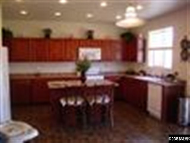8983 Mahon Drive Reno, NV 89506 - Photo 2 of 8 a kitchen with a sink and cabinets