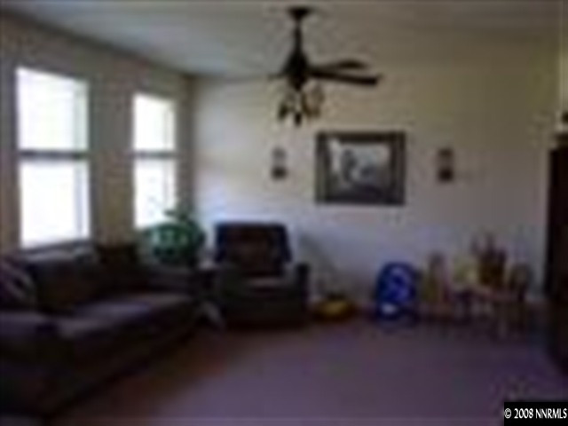 8983 Mahon Drive Reno, NV 89506 - Photo 3 of 8 a living room with furniture and a flat screen tv