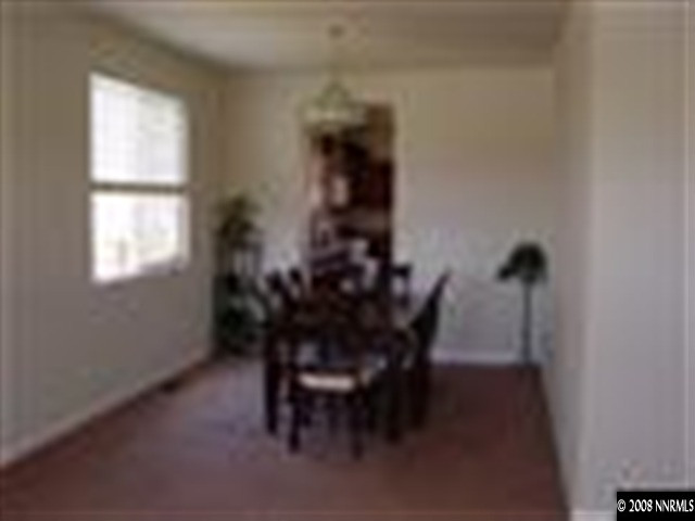 8983 Mahon Drive Reno, NV 89506 - Photo 4 of 8 a view of a dining room with furniture and a window